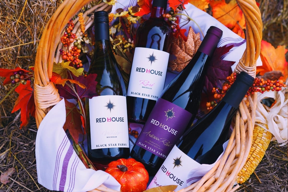 Red House Wine collection in a basket with fall decorations.