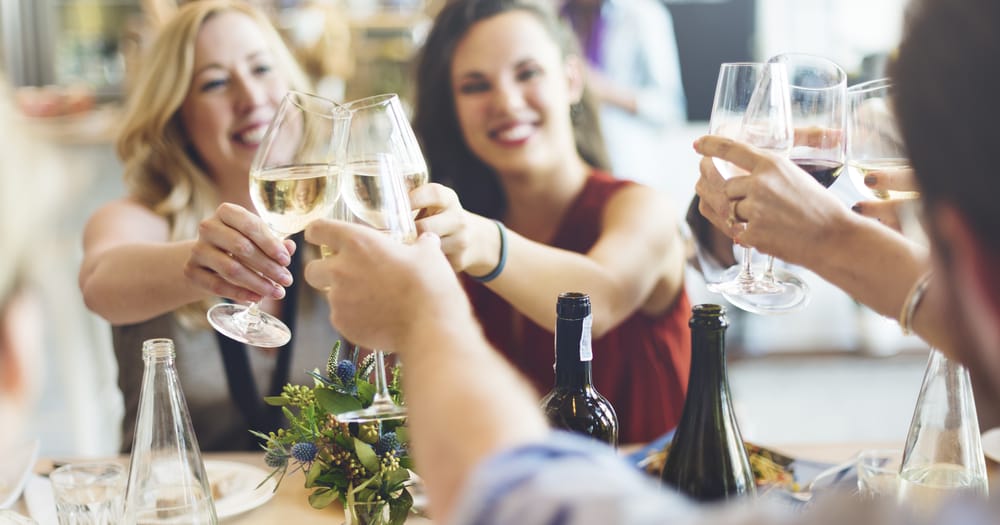 Group of girlfriends enjoying the best wine tasting in Traverse City on Traverse City wine tours